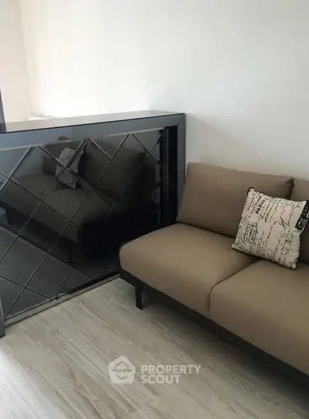 Modern living room with stylish sofa and mirrored accent wall