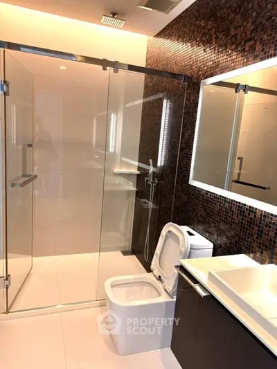 Luxurious modern bathroom with glass shower and elegant fixtures