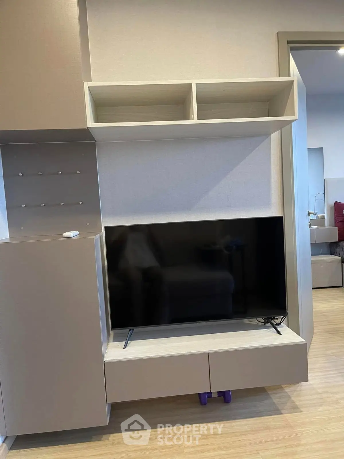 Modern living room with sleek TV unit and open shelving, perfect for contemporary living.