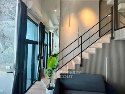 Modern duplex interior with stylish staircase and large windows
