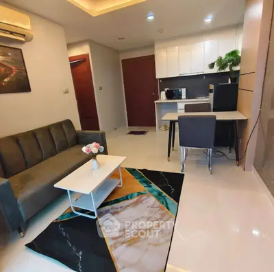 Modern living room with stylish decor and open kitchen layout in a contemporary apartment.