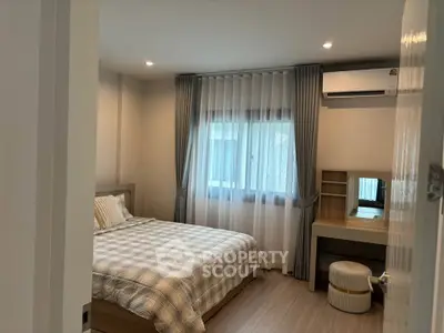 Cozy bedroom with modern decor and natural light, featuring a comfortable bed and stylish furnishings.