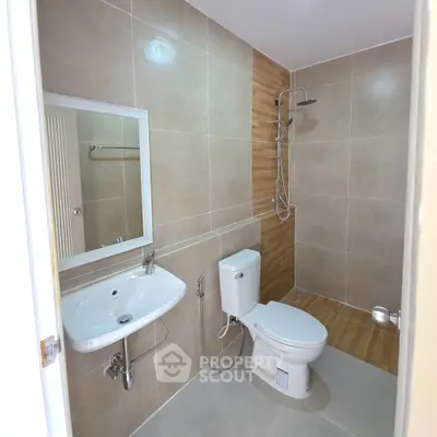 Modern bathroom with sleek fixtures and spacious shower area