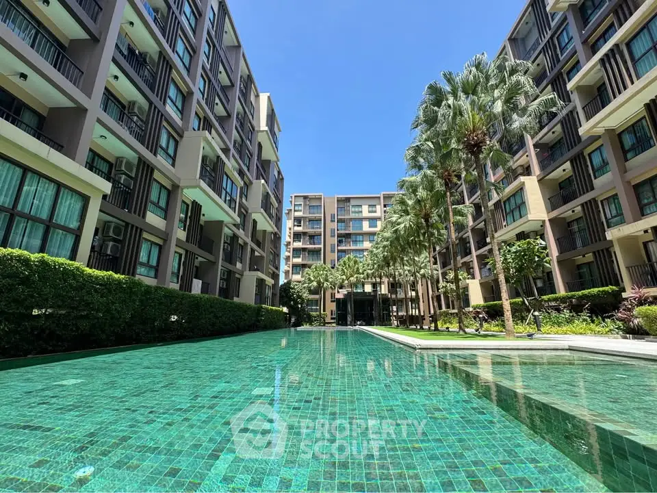 Luxurious condominium with stunning pool and lush greenery, perfect for modern living.