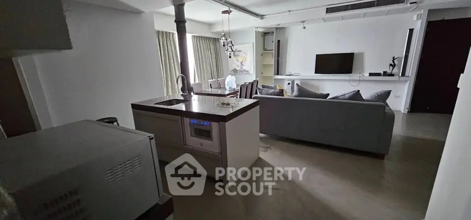 Modern living room with open kitchen layout and stylish decor