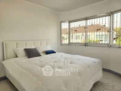 Bright bedroom with large windows and cozy bed in modern home