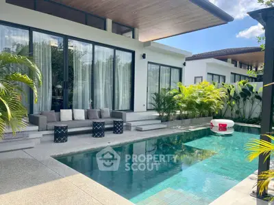 Luxurious modern villa with private pool and lush greenery, perfect for relaxation and entertaining.