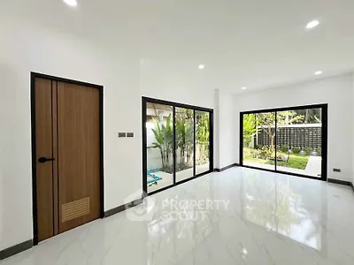 Spacious modern living room with large windows and garden view