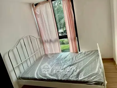 Cozy bedroom with natural light and modern bed frame, perfect for restful nights.