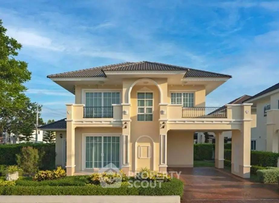 Elegant two-story house with a spacious driveway and lush greenery, perfect for family living.