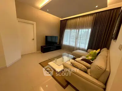 Elegant living room with modern decor, plush sofa, and large window for natural light.