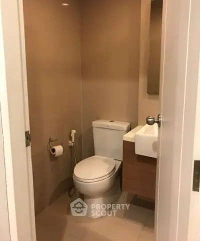 Compact modern bathroom with sleek fixtures and neutral tones