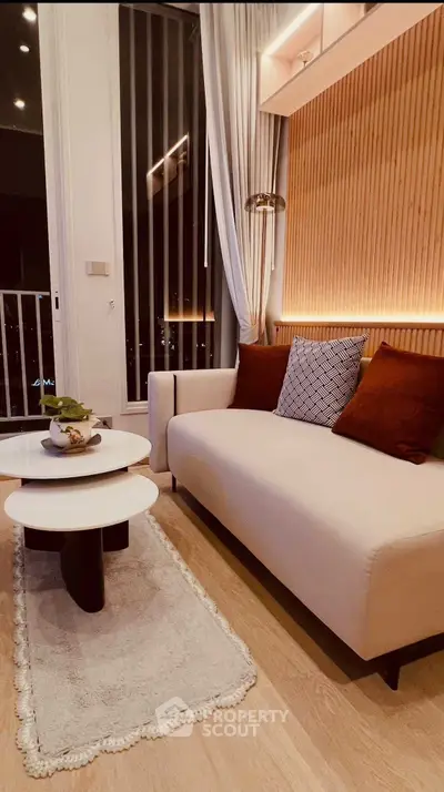 Stylish modern living room with cozy sofa, elegant lighting, and chic decor, perfect for urban living.