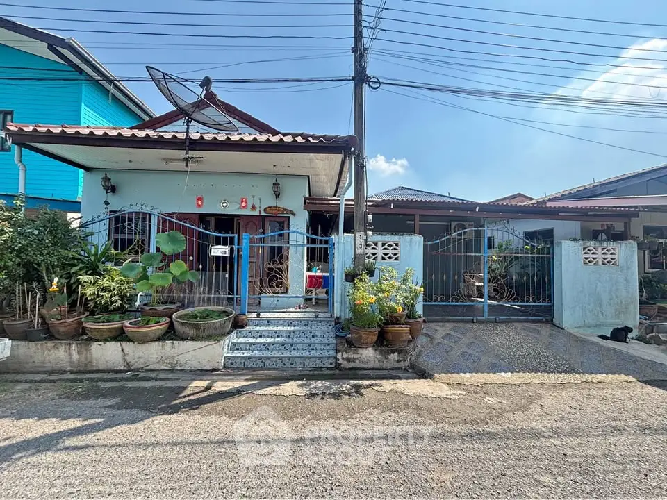 Charming single-story home with gated entrance and lush garden in a peaceful neighborhood.