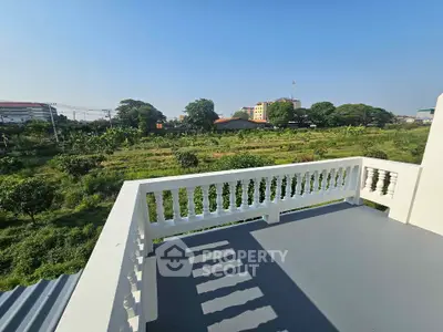 Spacious balcony with scenic green view in urban setting, perfect for relaxation and outdoor enjoyment.