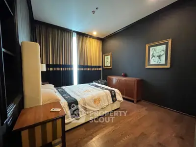 Luxurious bedroom with elegant decor and hardwood flooring in a modern apartment.