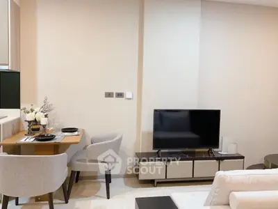 Modern living room with cozy dining area and sleek TV setup, perfect for urban living.
