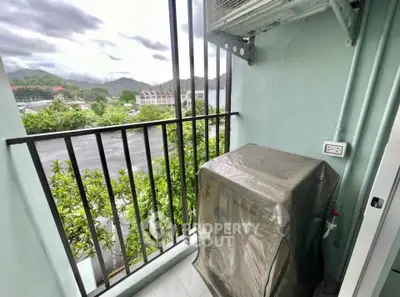 Charming balcony with lush greenery and mountain views, perfect for relaxation.
