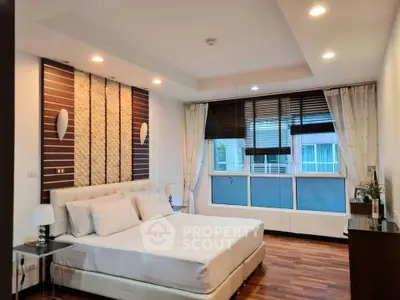 Spacious modern bedroom with elegant decor and large windows in a luxury apartment.