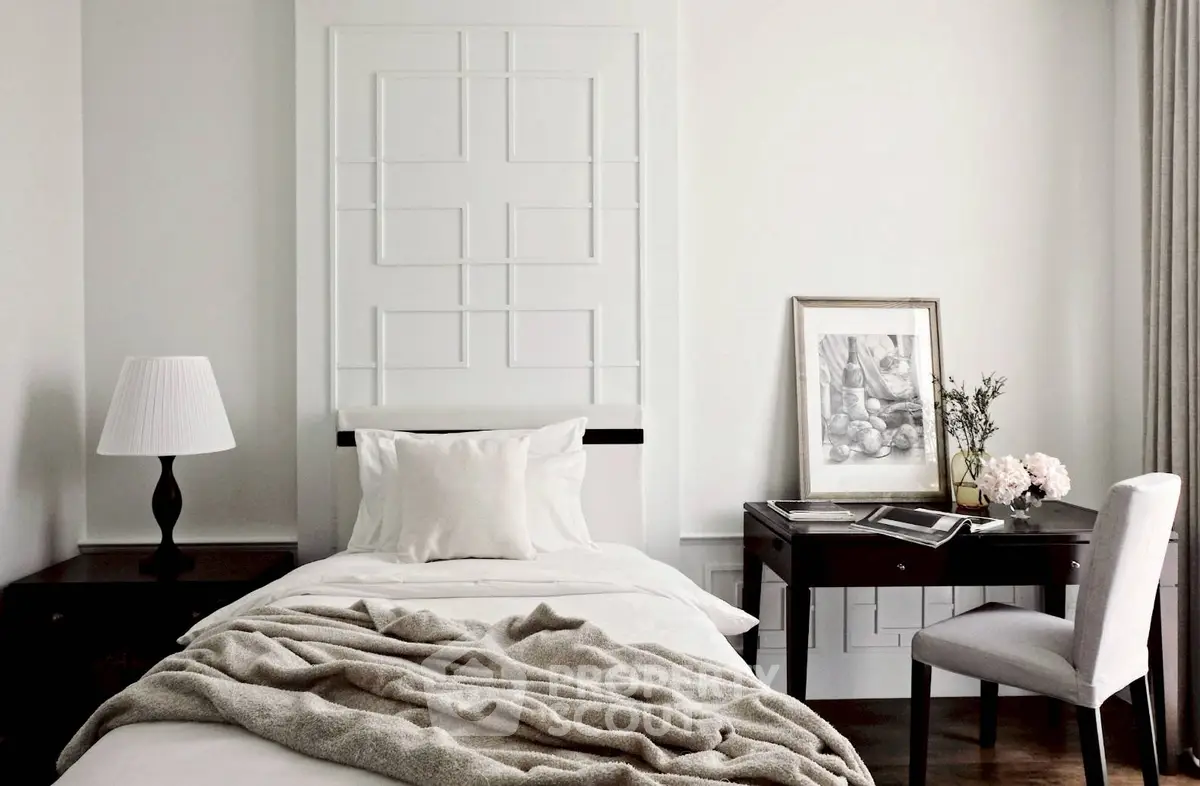 Elegant bedroom with modern decor, featuring a cozy bed, stylish desk, and chic lighting.