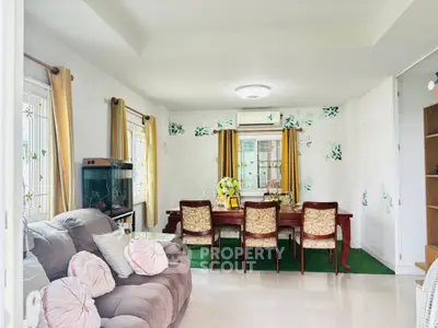 Charming living room with elegant dining area and cozy seating, perfect for family gatherings.