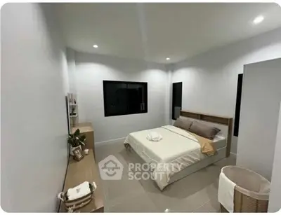 Modern minimalist bedroom with sleek design and neutral tones, featuring a cozy bed and stylish decor.