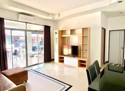 Spacious living room with modern furniture and large windows offering natural light.