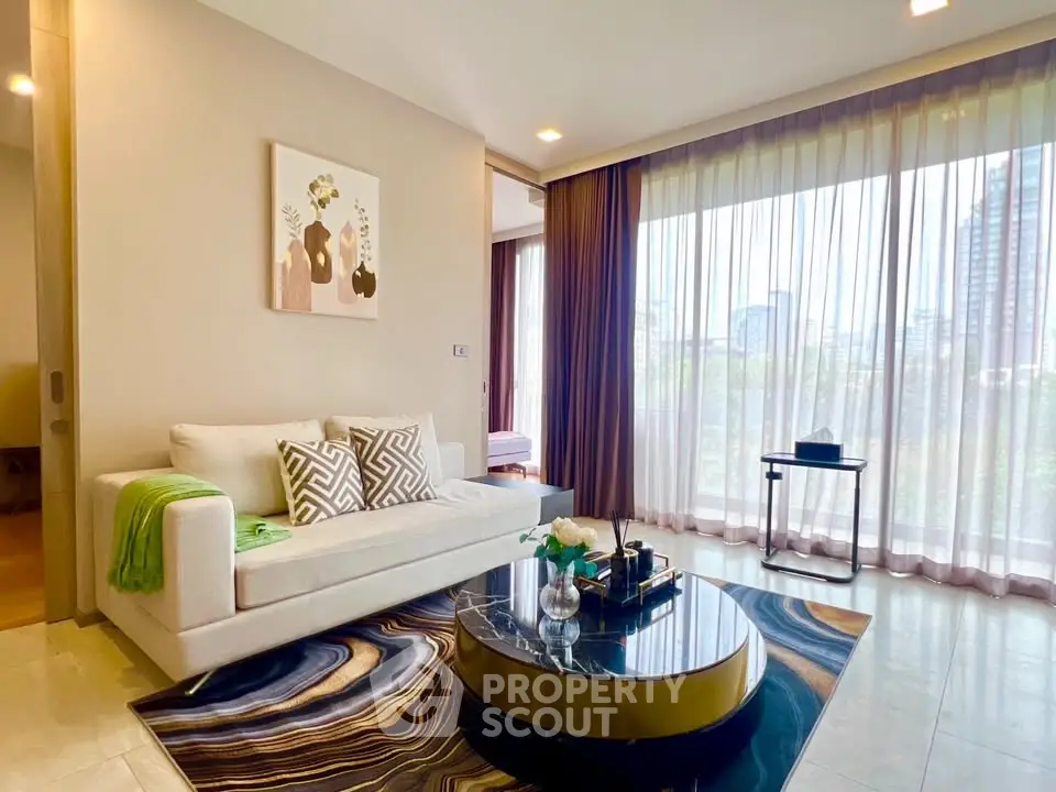 Elegant living room with modern decor and large windows offering city views, featuring a stylish sofa and chic coffee table.