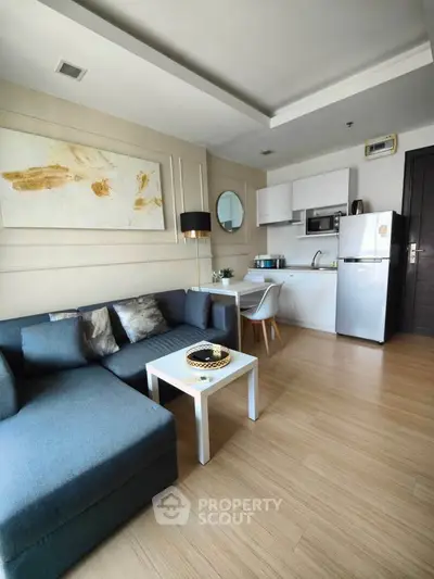 Modern living room with cozy sofa and compact kitchen in open layout