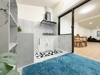 Modern kitchen with sleek design and open layout leading to dining area
