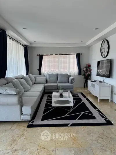Spacious living room with modern decor and large sectional sofa