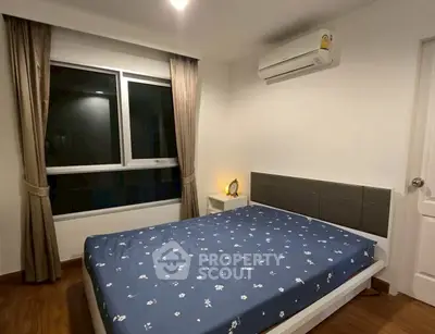 Cozy bedroom with modern decor and air conditioning in a stylish apartment.