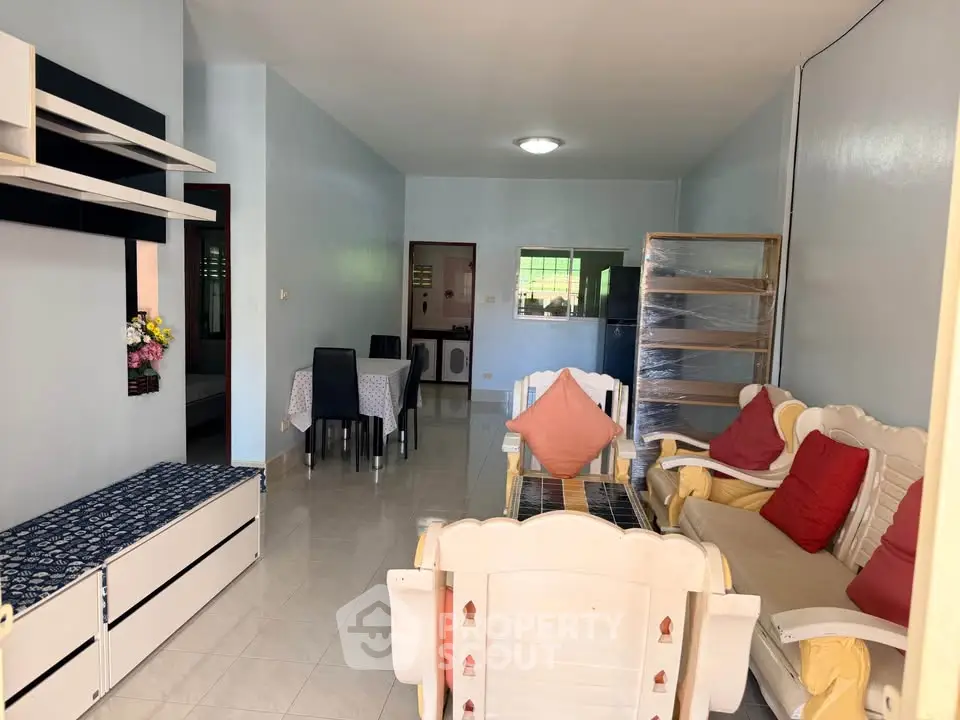 Spacious living room with cozy seating and dining area, perfect for family gatherings.