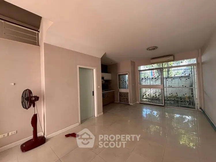 Spacious living room with large windows and modern design, perfect for natural light lovers.