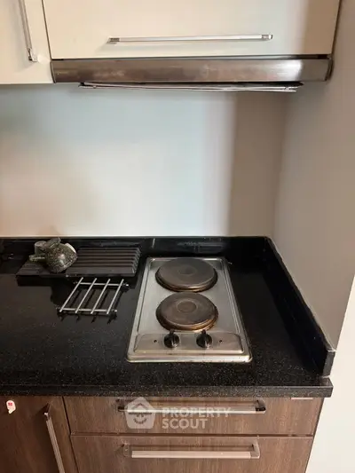 Modern kitchen with sleek black countertop and electric stove