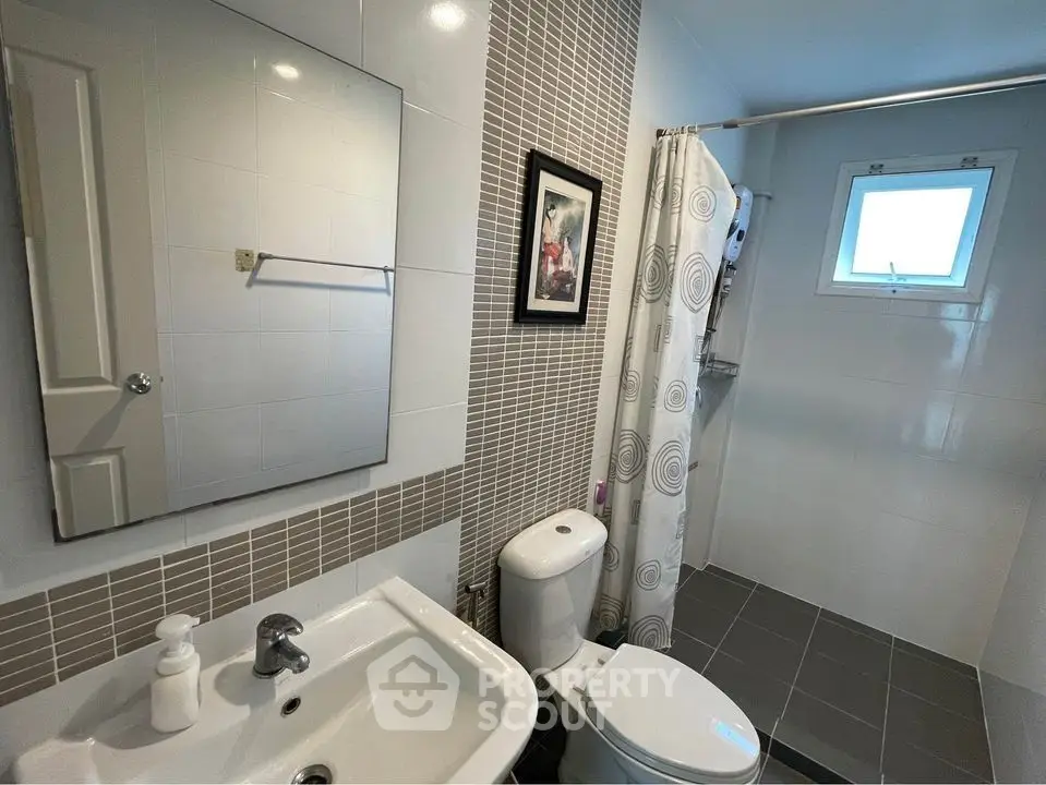 Modern bathroom with sleek tiles and natural light