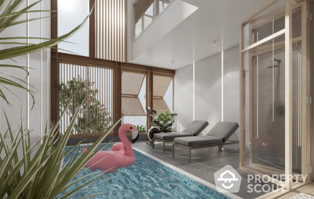 Luxurious indoor pool area with modern design and natural light, featuring a pink flamingo float and stylish loungers.