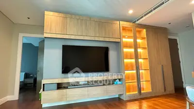 Modern living room with sleek wooden entertainment center and ambient lighting