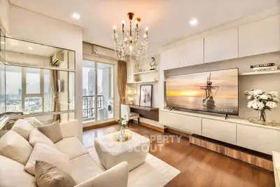 Luxurious living room with elegant chandelier and stunning city view balcony.