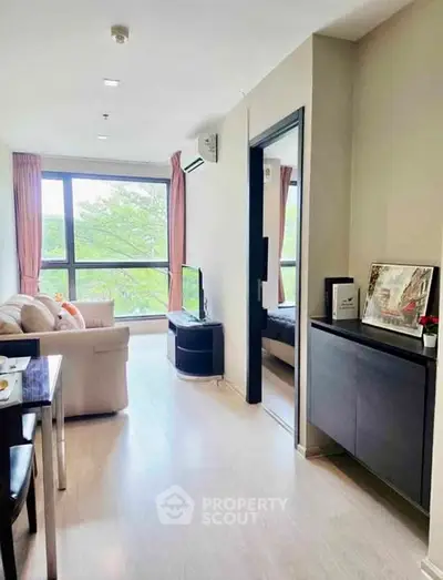 Bright and airy living room with large windows and modern decor in a stylish apartment.