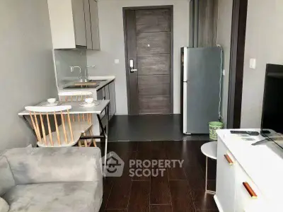 Modern compact apartment with cozy living area and sleek kitchen design.