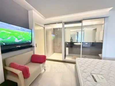 Modern studio apartment with open layout, featuring a cozy living area and sleek bathroom design.