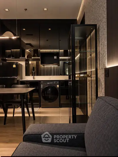 Modern apartment interior with sleek kitchen and cozy living area, featuring stylish furniture and appliances.