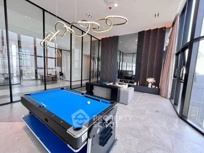 Luxurious modern living room with pool table and stylish lighting in high-rise apartment.