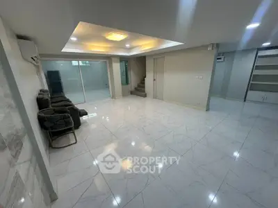 Spacious modern living room with sleek marble flooring and recessed lighting