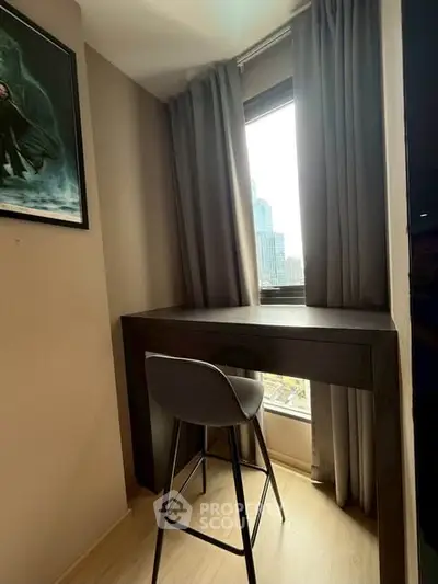 Cozy study nook with a modern desk and chair by a window with city view.
