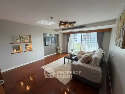 Spacious living room with modern decor and large windows offering natural light.