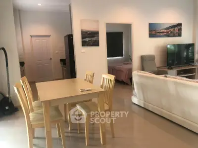 Modern open-plan living room with dining area and cozy decor
