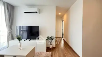 Modern living room with sleek TV setup and air conditioning