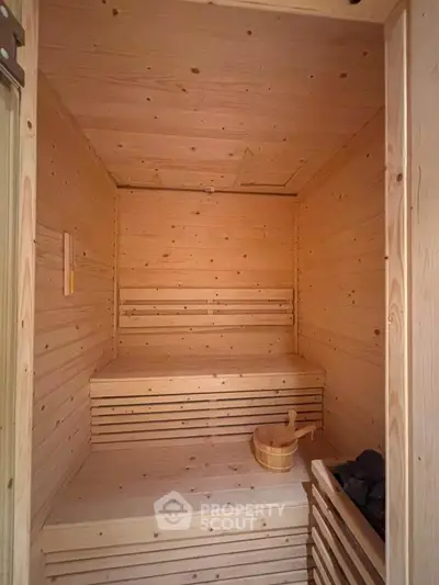 Luxurious wooden sauna interior with warm lighting and traditional design, perfect for relaxation and wellness.